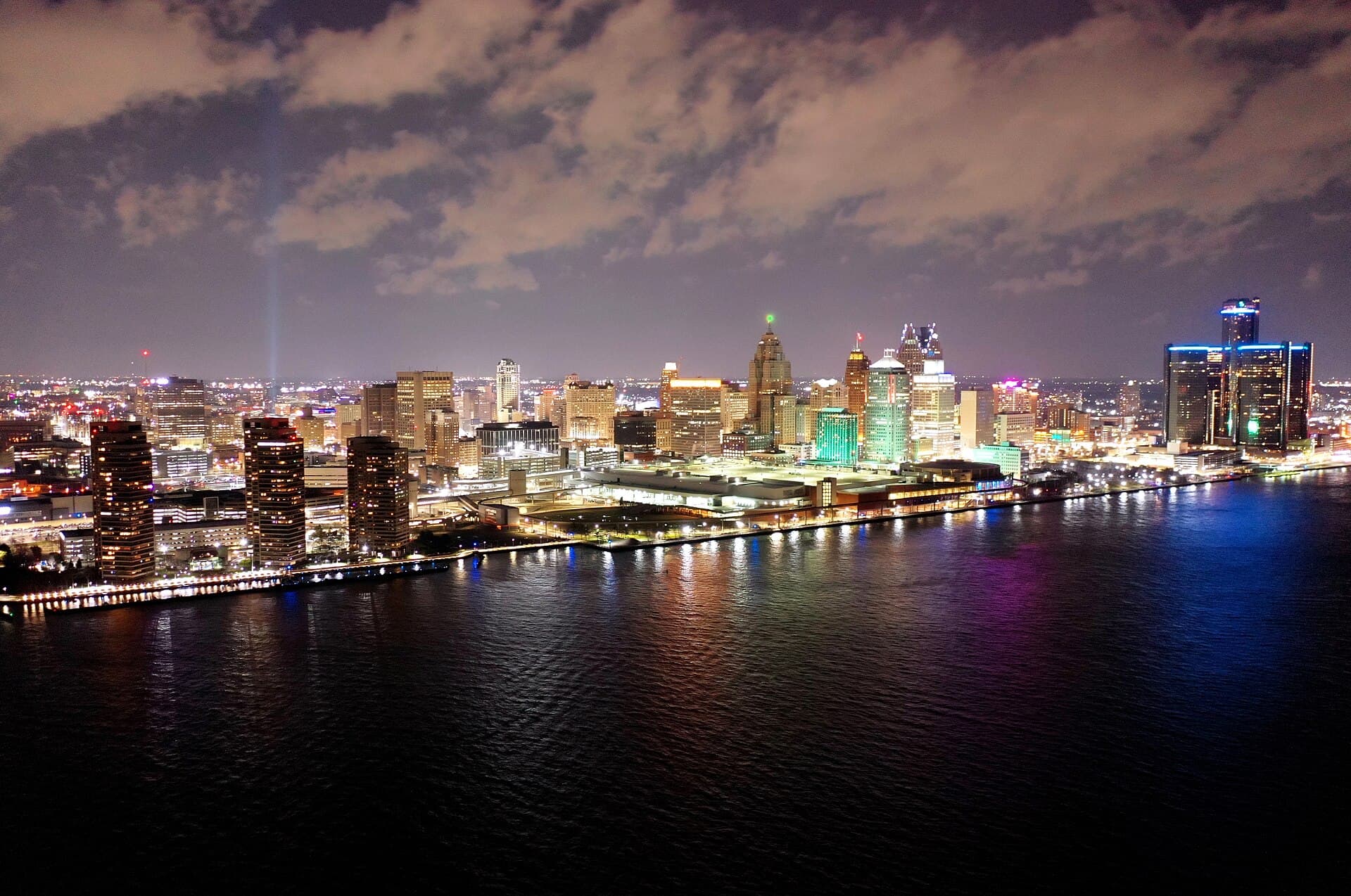 Downtown Detroit skyline lit up at night across the Detroit River