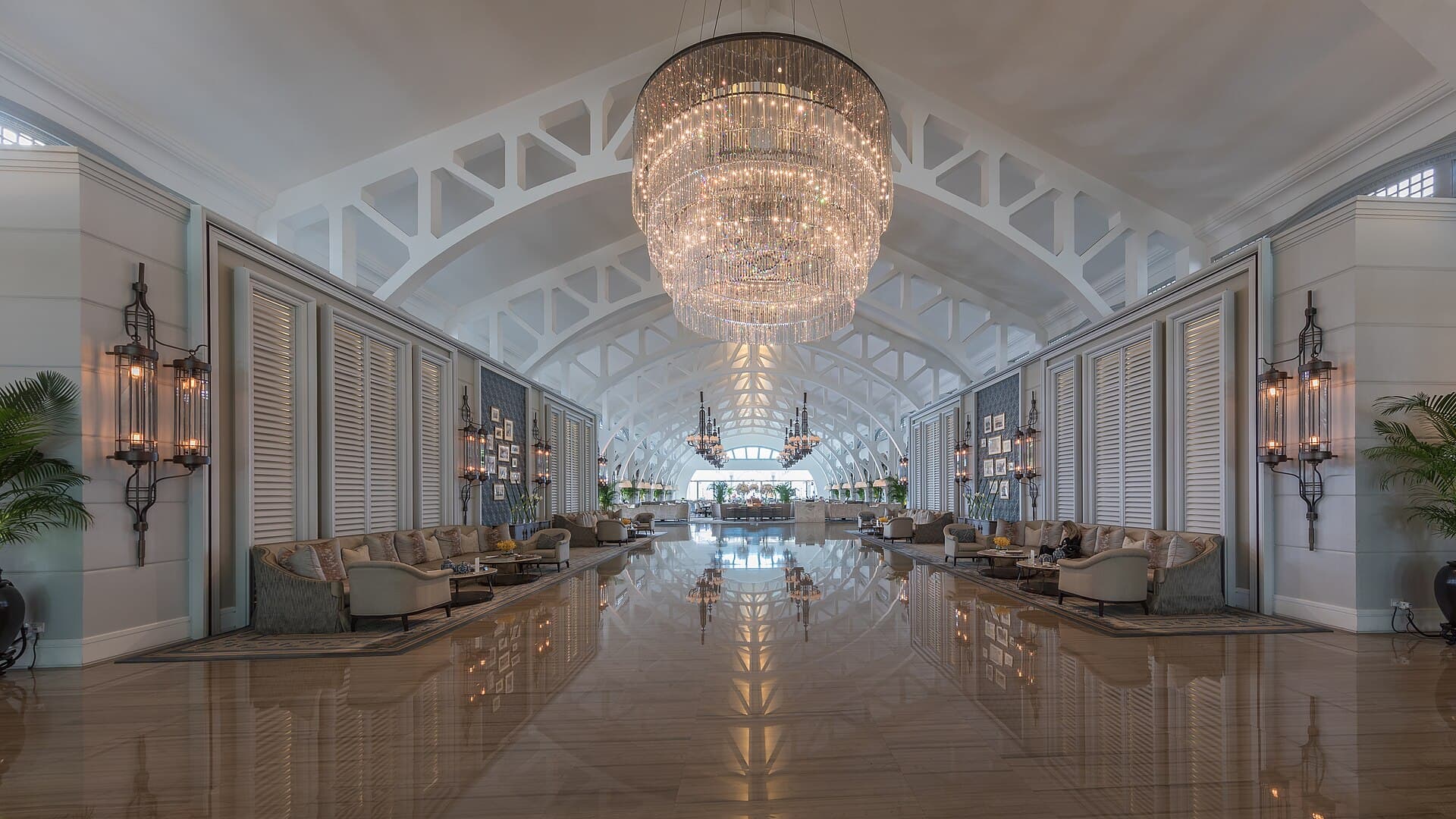 Grand hotel lobby with a crystal chandelier and polished marble floor